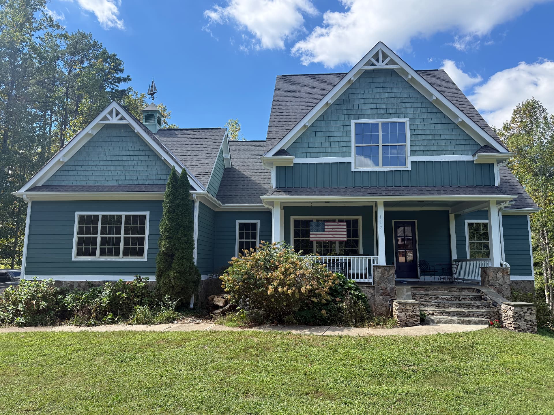 Finished exterior repaint of a Troutman home with Rocky River siding, Jasper Stone cedar shake gables, and Extra White trim