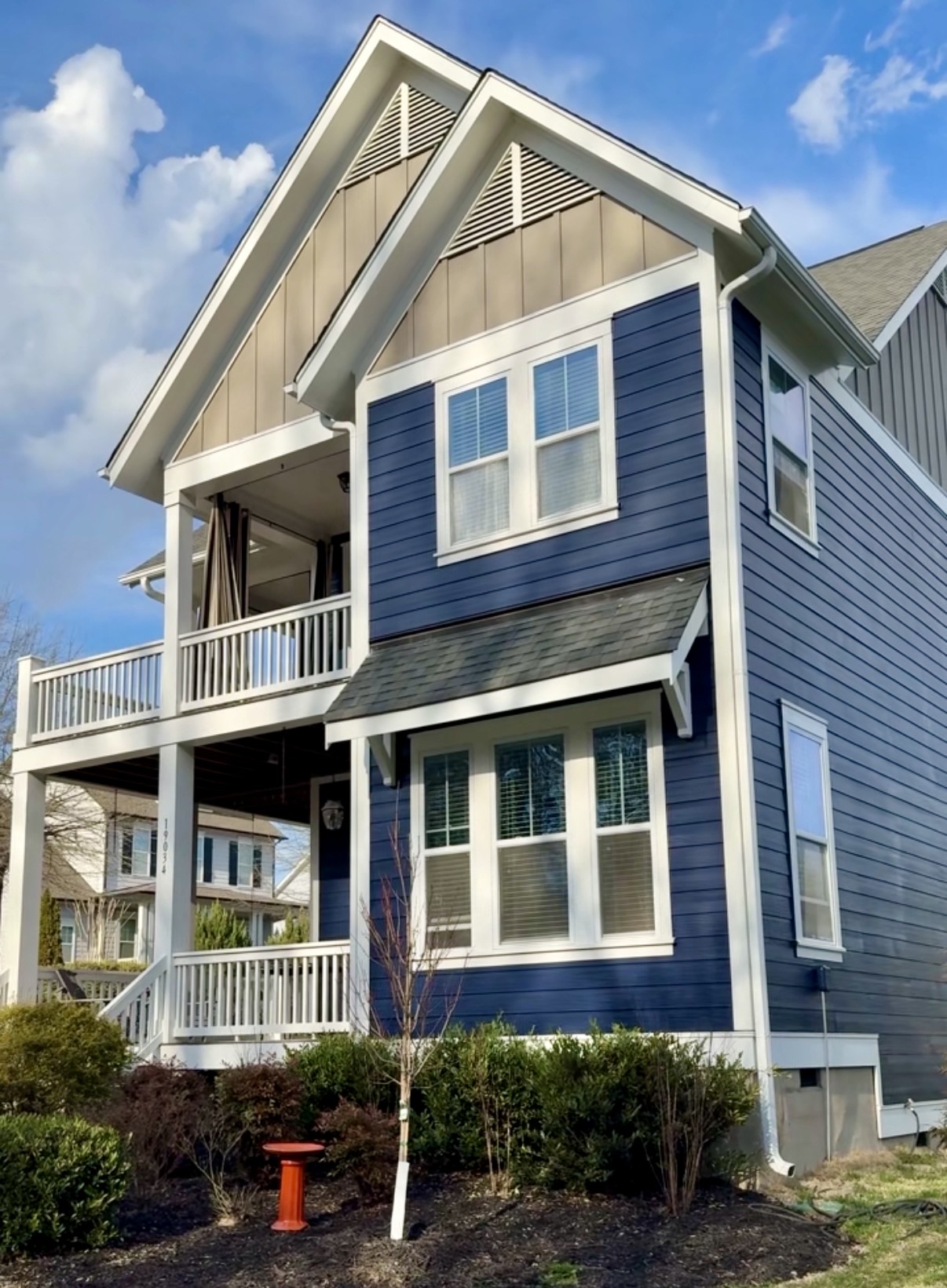 Finished exterior repaint of a Cornelius home with deep blue Naval siding