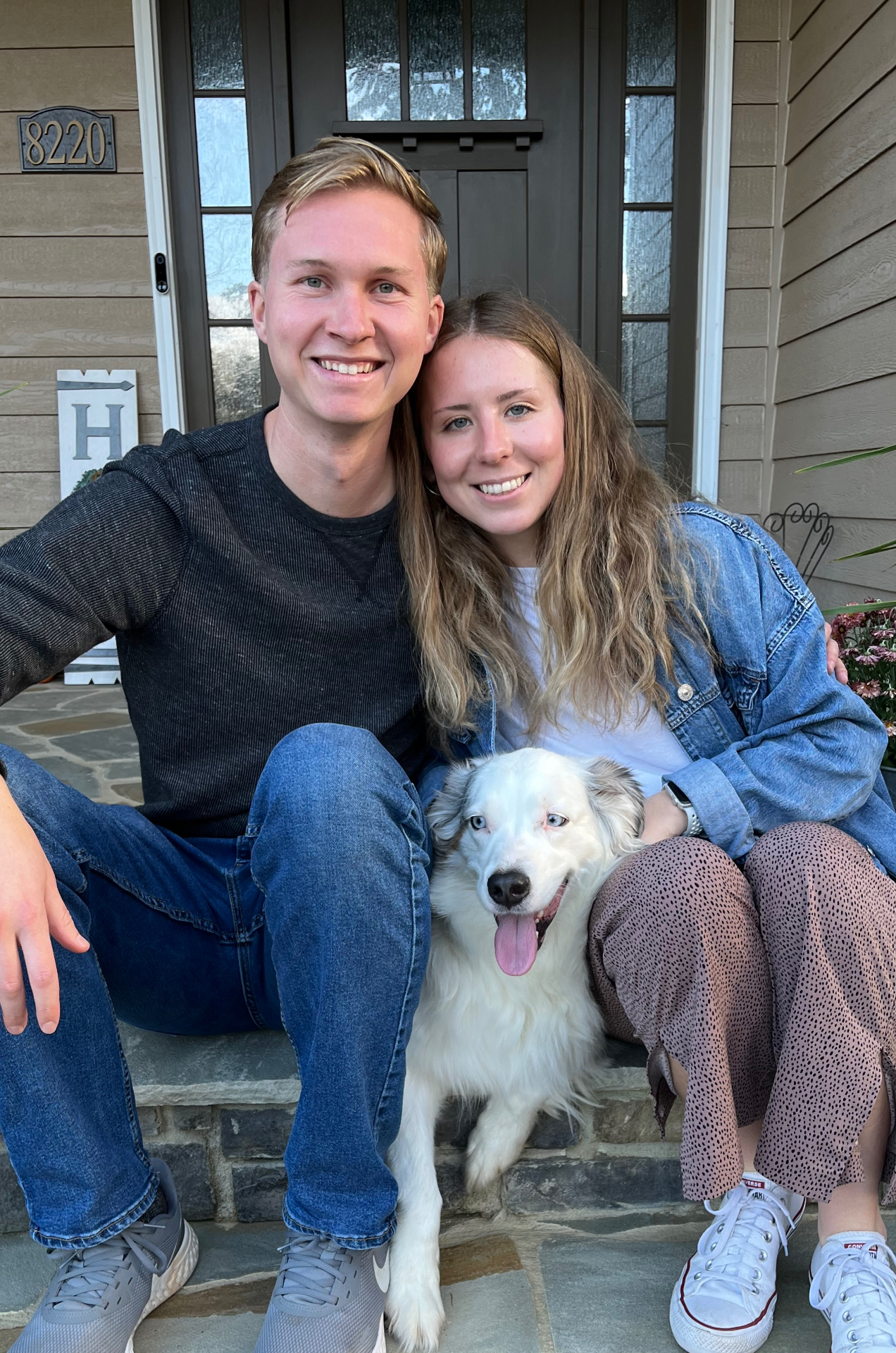 The owners of Trailblaze Paints with their dog on a Mooresville, NC front porch