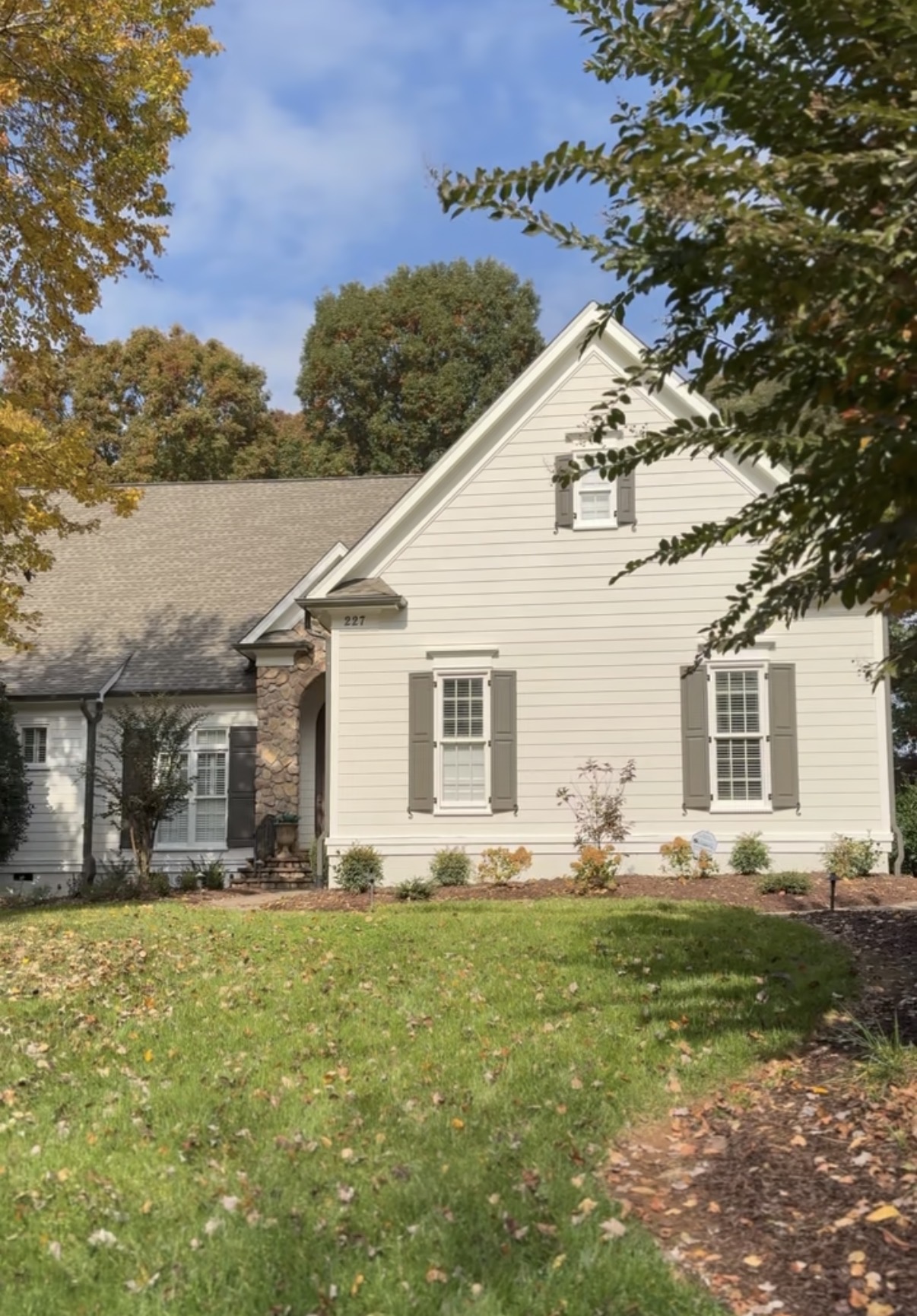 Finished exterior repaint of a Mooresville home with Natural Choice siding, Greek Villa trim, and Urbane Bronze shutters and garage doors