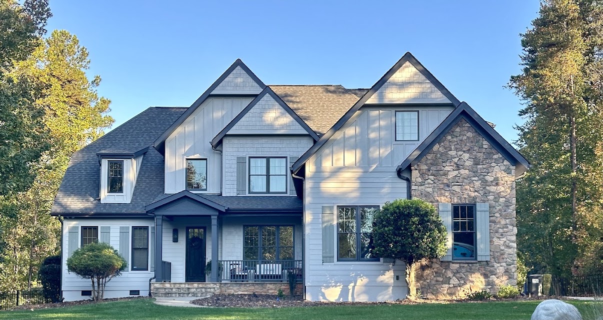 Finished exterior repaint of a Mooresville home with light gray-blue siding and dark trim