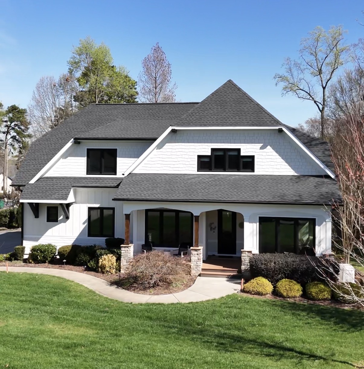 White farmhouse style home with black windows painted in White Duck and Tricorn Black