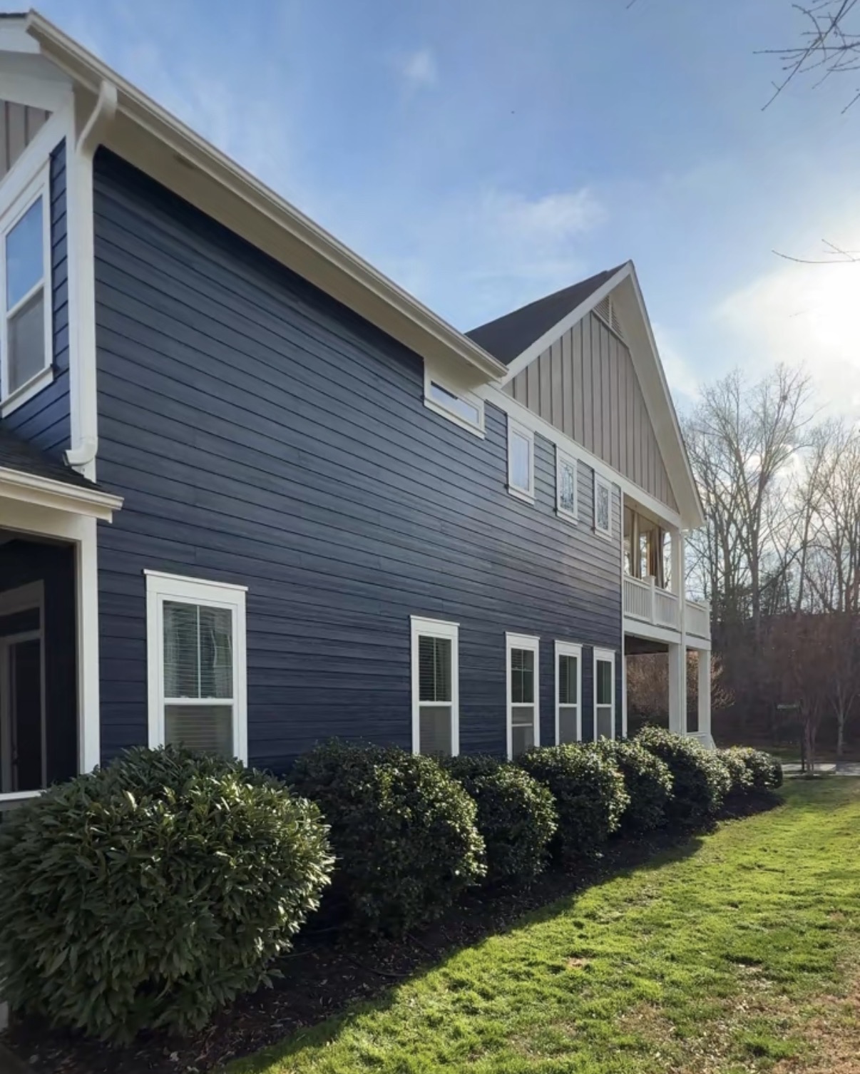 Deep navy home exterior with crisp white trim painted in Naval and Extra White